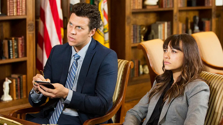 Jay Geils (Hayes MacArthur) and Angie Tribeca (Rashida Jones) sit at a desk questioning a person of interest in Angie Tribeca