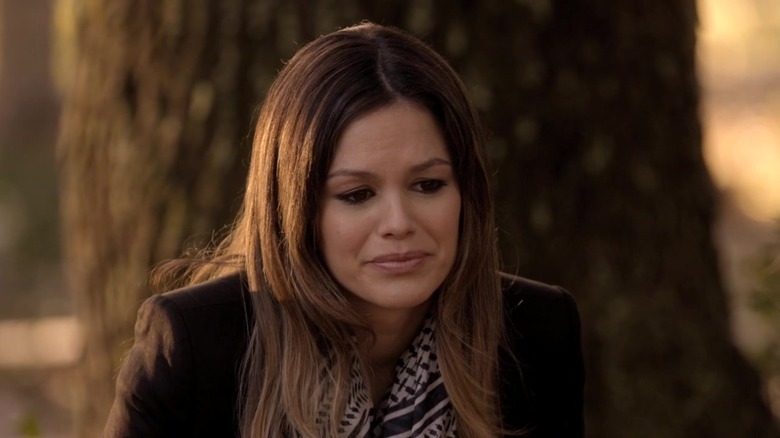 Rachel Bilson as Zoe in coat and scarf looking sad in front of tree in Hart of Dixie