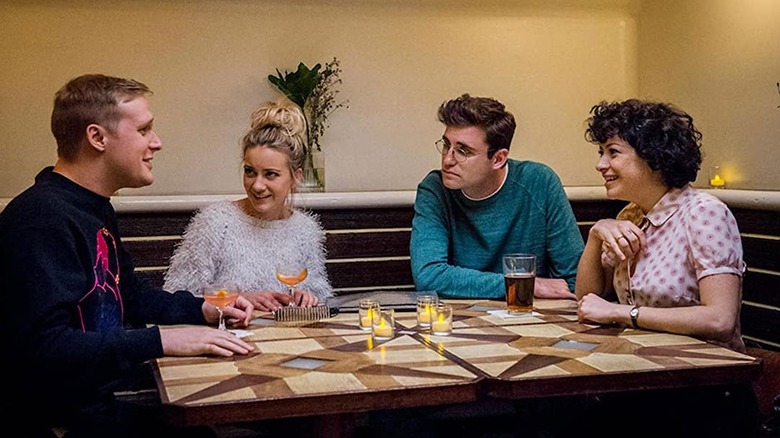 Four young adults meet over drinks