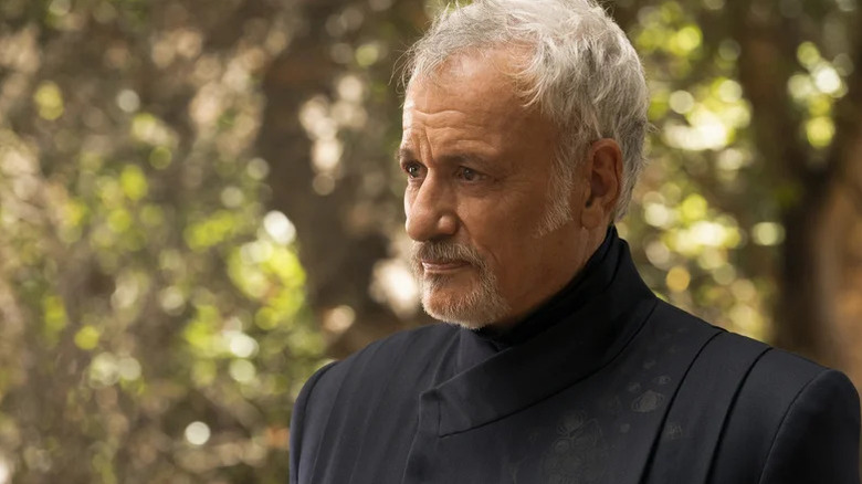 An older Q (John De Lancie) stands outside clad in all black in Star Trek: Picard