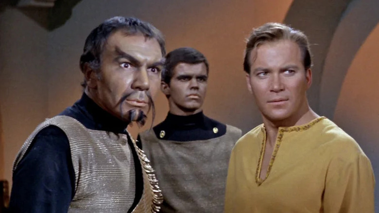 Kor (John Colicos) stands next to James Kirk (William Shatner) in Star Trek: The Original Series