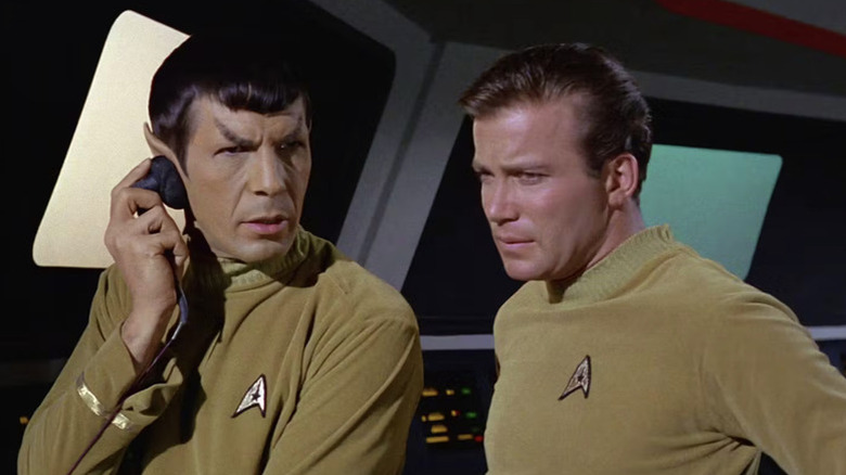 Spock (Leonard Nimoy) listens to sensors as James Kirk (William Shatner) watches in Star Trek: The Original Series