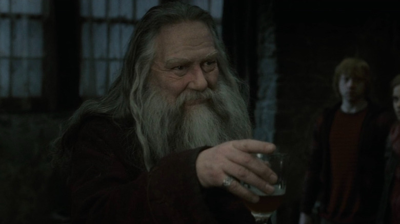 Aberforth Dumbledore (Ciarán Hinds) holding a drink in Harry Potter and the Deathly Hallows - Part 2