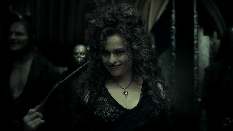 Bellatrix Lestrange (Helena Bonham Carter) pointing a wand at her face in Harry Potter and the Half Blood Prince