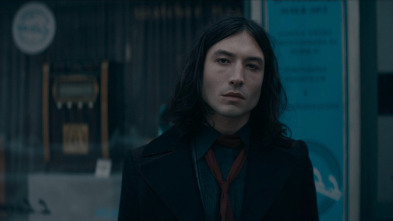 Credence Barebone (Ezra Miller) standing on the street in Fantastic Beasts: The Secrets of Dumbledore