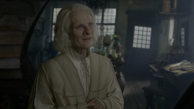Nicolas Flamel (Brontis Jodorowsky) in his shop in Fantastic Beasts: The Crimes of Grindelwald