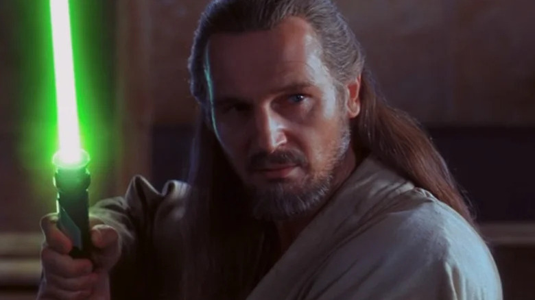 Qui-Gon Jinn (Liam Neeson) stands by his ignited green lightsaber in Star Wars Episode I: The Phantom Menace