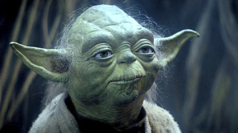 Yoda (Frank Oz) stands under a bright light in The Empire Strikes Back