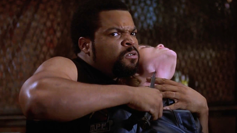 Ice Cube as Desolation Williams holds a knife to a victim's throat in Ghosts of Mars