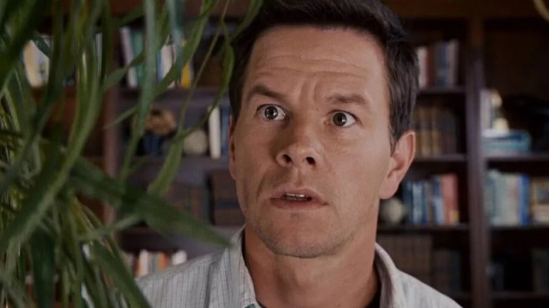Mark Wahlberg as Elliot Moore stares wide-eyed at a plant in The Happening