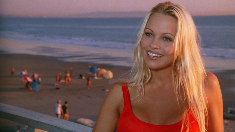 C. J. Parker (Pamela Anderson) talks to someone on duty on Baywatch