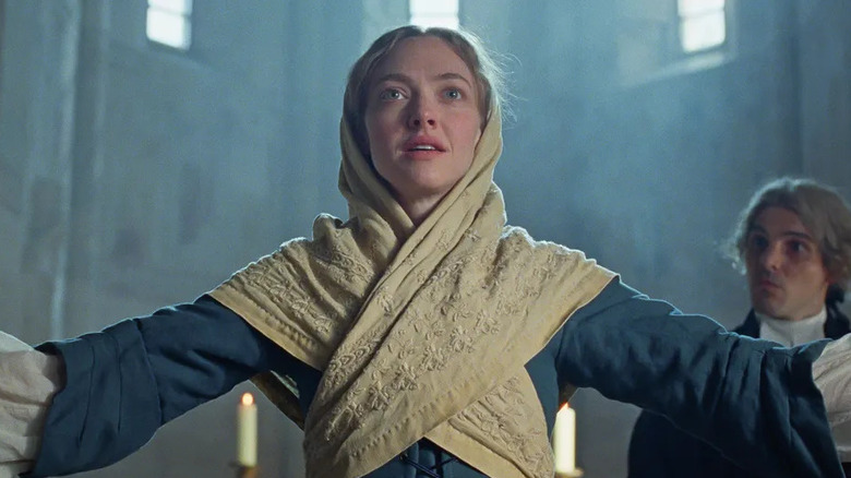 Ann Lee (Amanda Seyfried) with arms extended in The Testament of Ann Lee