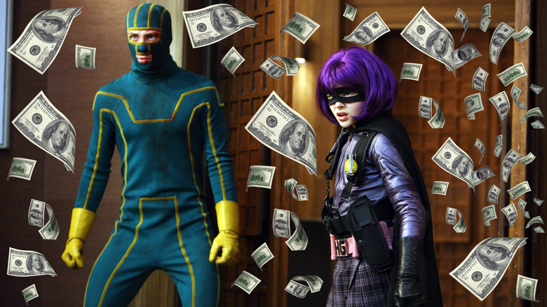 Aaron Taylor-Johnson as Kick-Ass and Chloe Grace Moretz as Hit-Girl standing side by side surrounded by money in Kick-Ass