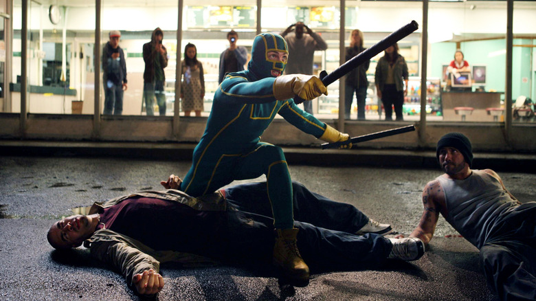 Aaron Taylor-Johnson as Kick-Ass standing over the guys he just beat up in Kick-Ass