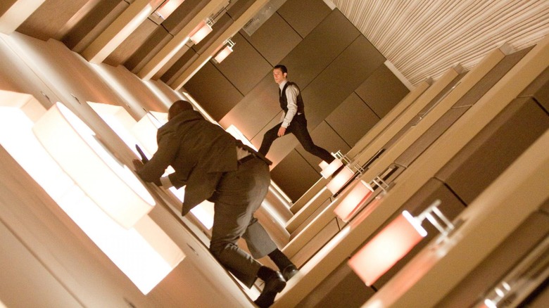Arthur fighting security guards in zero gravity in the hallway in Inception