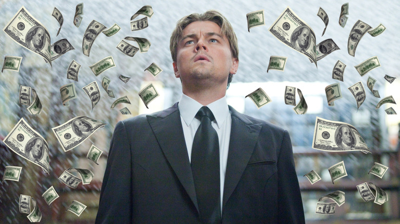 Leonardo DiCaprio as Cobb surrounded by water and money in Inception