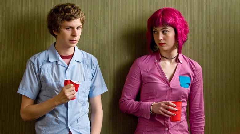 Michael Cera as Scott Pilgrim standing next to Mary Elizabeth Winstead as Ramona Flowers at the party in Scott Pilgrim vs. the World
