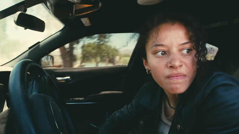 Willa Ferguson angrily driving a car in One Battle After Another
