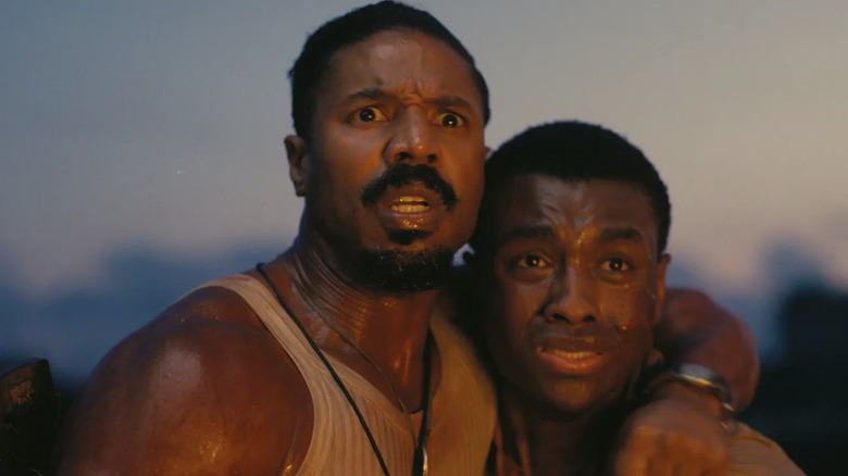 Michael B. Jordan's Elias "Stack" Moore and Miles Caton's Sammie Moore looking horrified in Sinners