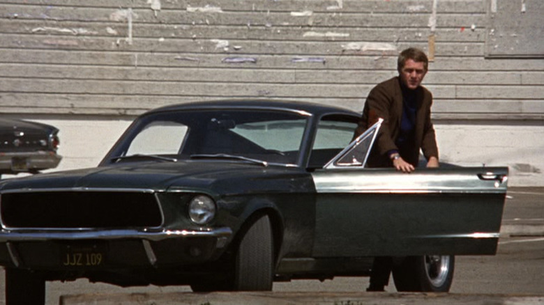 Steve McQueen getting out of car