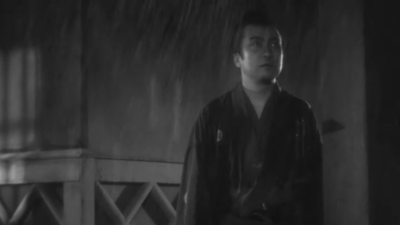 Matajuro Unno standing out in the rain
