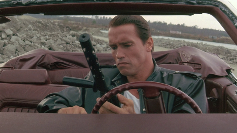 Arnold Schwarzenegger reloading in a convertible
