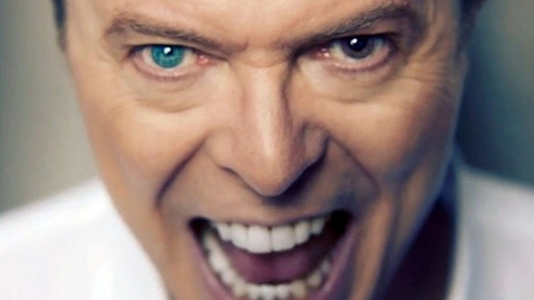 David Bowie singing into camera