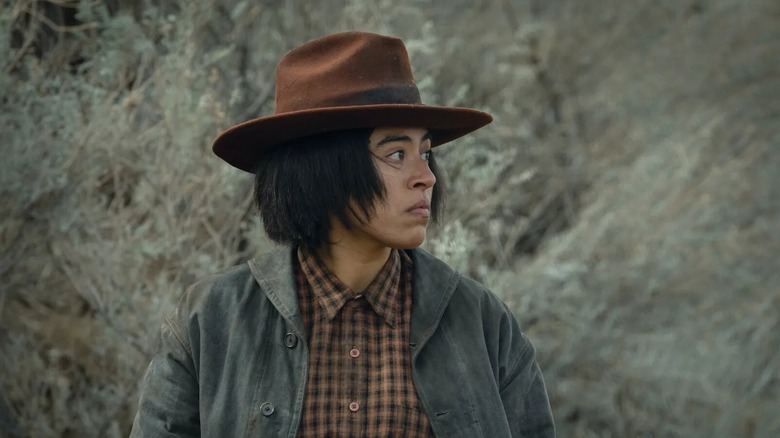 Teonna Rainwater dressed in a hat and flannel shirt