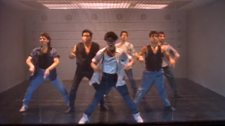 A group of dancers in an interrogation room, a scene from Cop Rock.