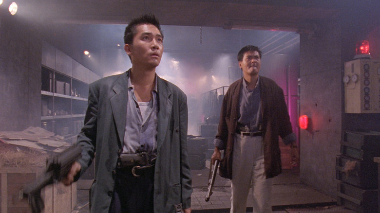 Alan (Tony Leung) and Tequila (Chow Yun-fat) looks up while walking through a storage basement in Hard Boiled