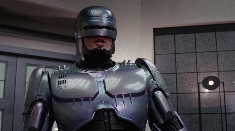 RoboCop (Peter Weller) speaks in an office in RoboCop (1987)