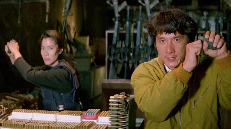 Jessica Yang (Michelle Yeoh) and Chan Ka-Kui (Jackie Chan) hold up grenades in an armory in Supercop