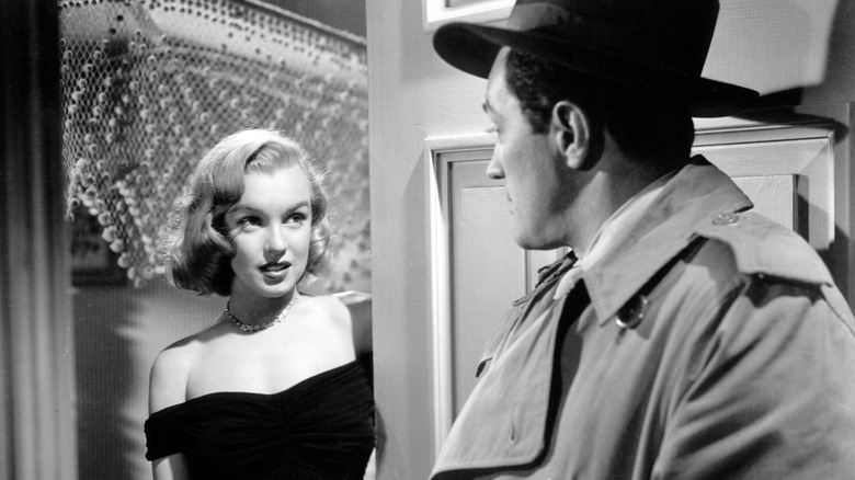 Angela Phinlay (Marilyn Monroe) talks to Dix Handley (Sterling Hayden) at the door in The Asphalt Jungle