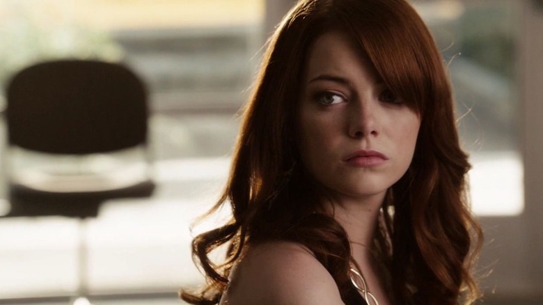 Emma Stone as Olive sitting in a classroom in Easy A, looking off at someone out of frame.