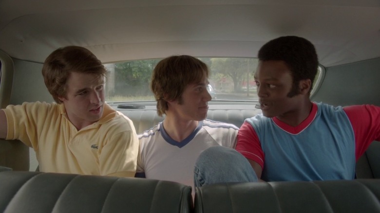 Blake Jenner, J. Quinton Johnson, and Temple Baker in Everybody Wants Some!!, sitting together in the back of a car.