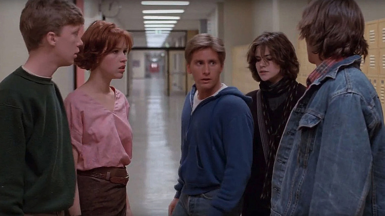The ensemble of The Breakfast Club: Emilio Estevez, Judd Nelson, Molly Ringwald, Anthony Michael Hall, and Ally Sheedy in a school hall