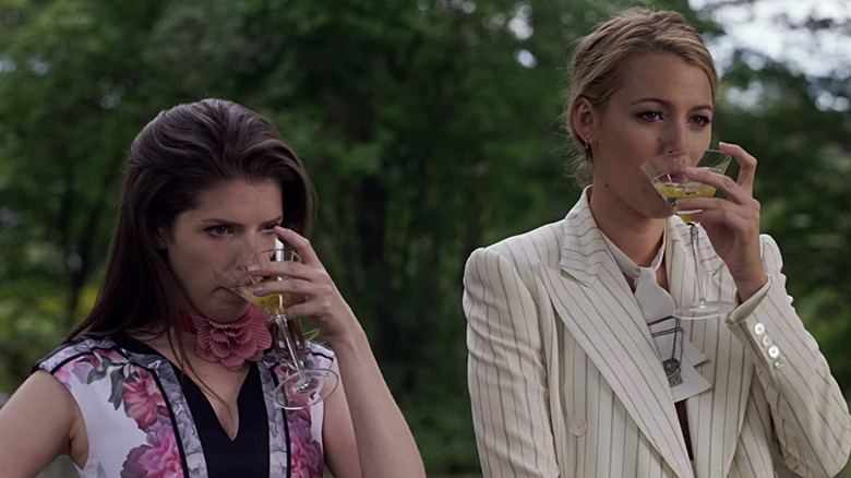 Anna Kendrick as Stephanie Smothers and Blake Lively as Emily Nelson drinking martinis in A Simple Favor