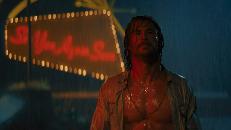 Chris Hemsworth as cult leader Billy Lee standing in the rain in Bad Times at the El Royale