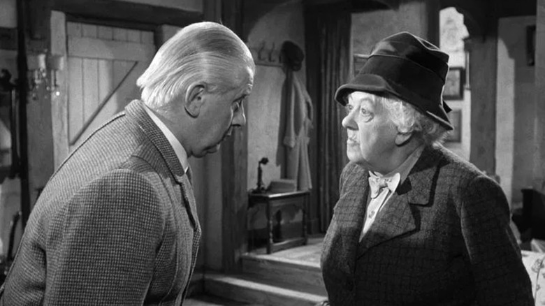 Stringer Davis as Mr Stringer talking to Margaret Rutherford as Miss Marple in Murder at the Gallop