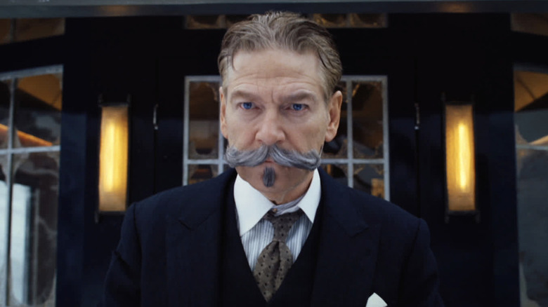 Kenneth Branagh as Hercule Poirot standing on the train in Murder on the Orient Express (2017)