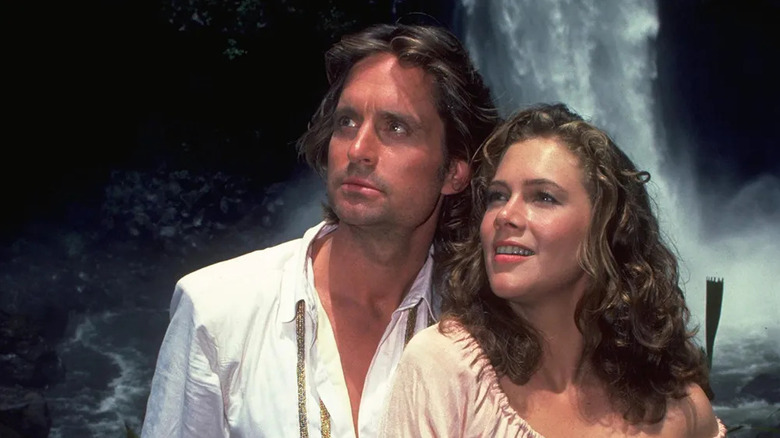 Michael Douglas and Kathleen Turner as Jack T. Colton and Joan Wilder, embracing in a cave in Romancing the Stone
