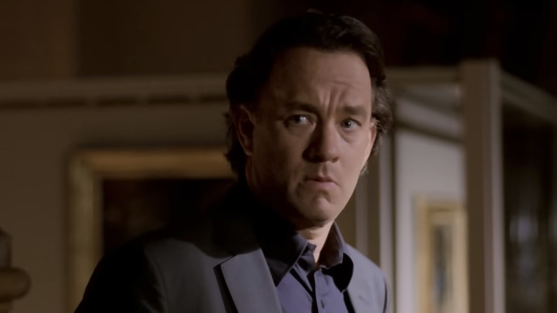 Tom Hanks as Robert Langdon, looking concerned in a museum in The Da Vinci Code
