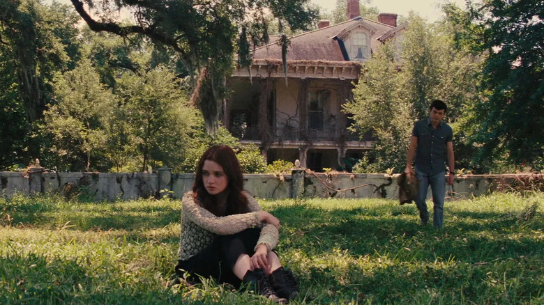 Lena (Alice Englert) sitting on ground as Ethan (Alden Ehrenreich) approaches in Beautiful Creatures