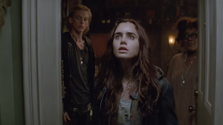 Clary (Lily Collins) in doorway looking up in The Mortal Instruments: City of Bone