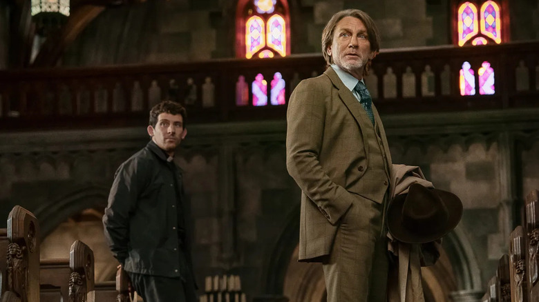 Jud and Blanc in the church looking over at someone in Wake Up Dead Man