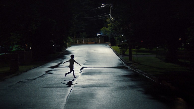 A child runs across a moonlit street in Weapons