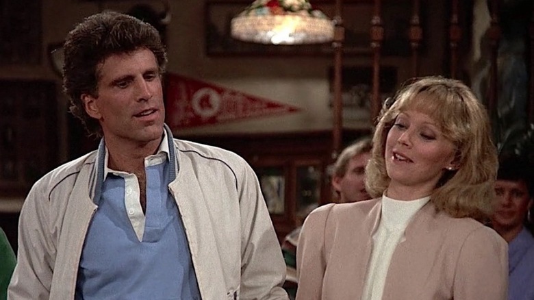 Ted Danson as Sam Malone standing next to Shelley Long as Diance Chambers while wearing jackets in Cheers