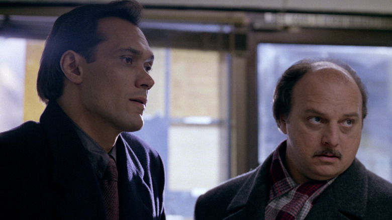 Jimmy Smits as Det. Bobby Simone standing nect to John Kelly and Andy Sipowicz in front of windows in NYPD Blue