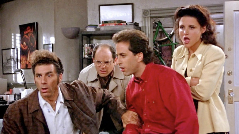 Michael Richards as Cosmo Kramer, Jason Alexander as George Costanza, Jerry Seinfeld as himself, and Julia Louis-Dreyfus as Elaine Benes all looking shocked in Jerry's living room in Seindelf