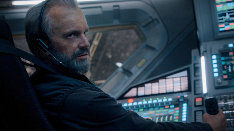Ed Baldwin (Joel Kinnaman) glances up while piloting a spaceship in For All Mankind